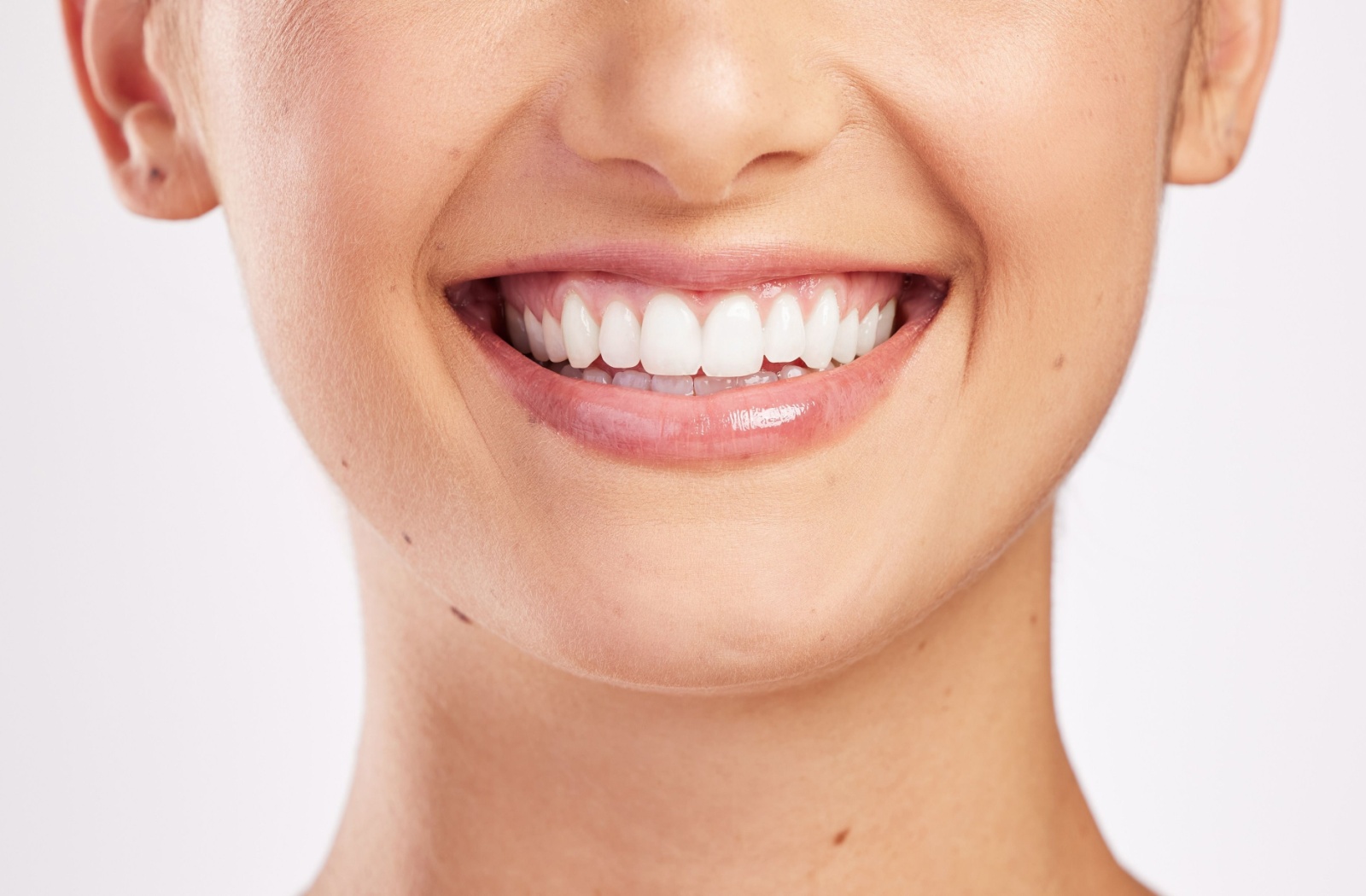 A patient smiling after getting their teeth cleaned.