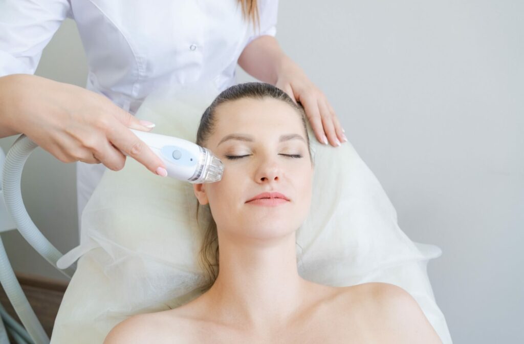 A relaxed adult undergoes a non-invasive facelift procedure.